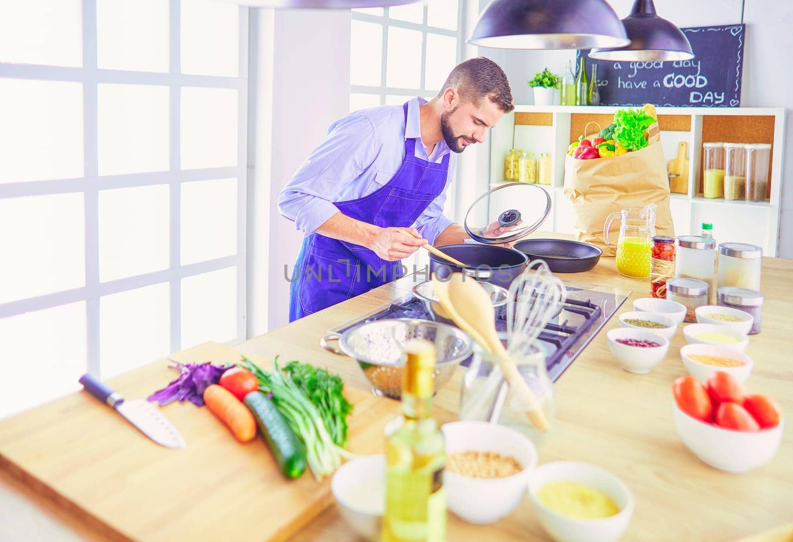 Man preparing delicious and healthy food in the home kitchen.