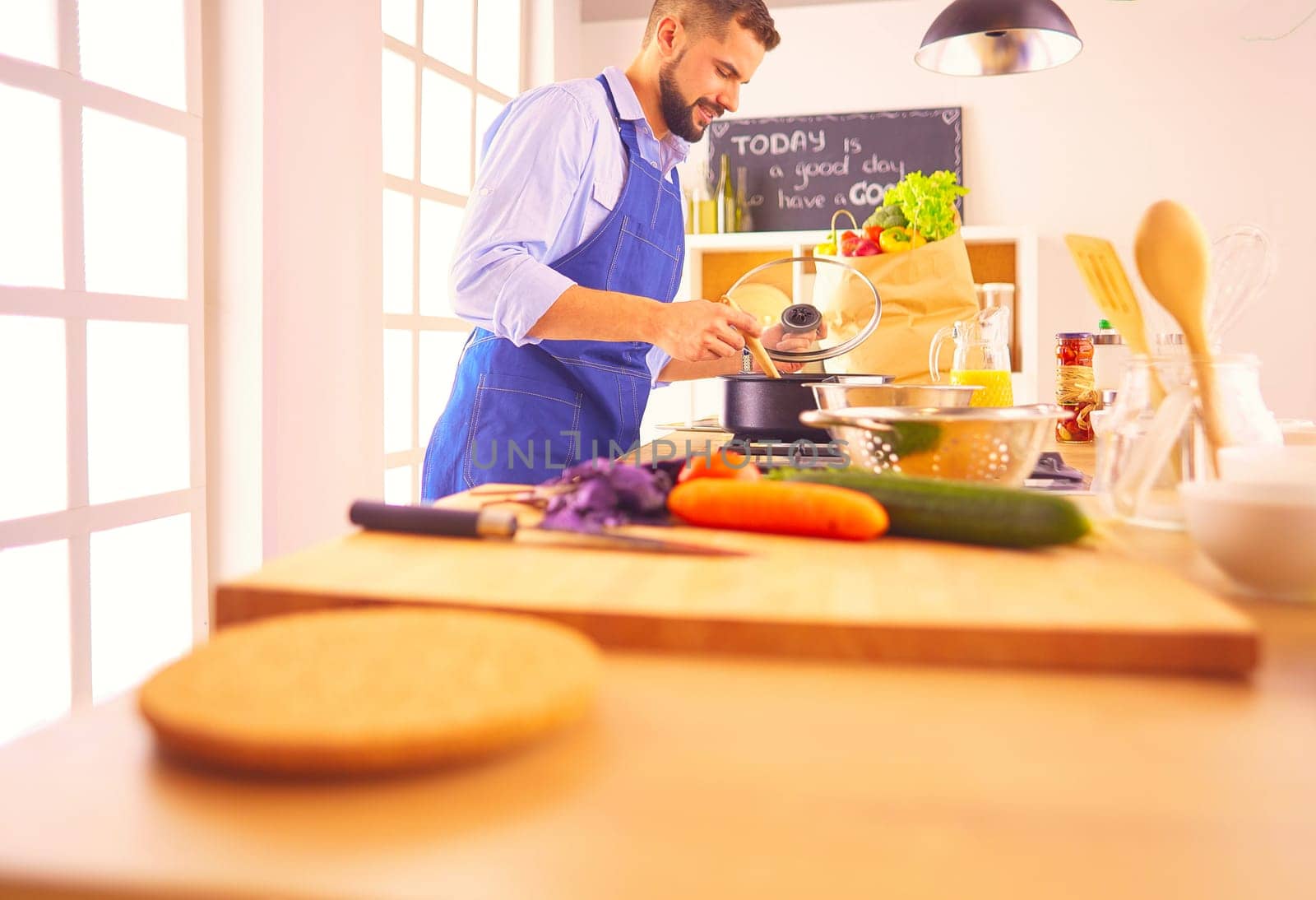 Man preparing delicious and healthy food in the home kitchen.