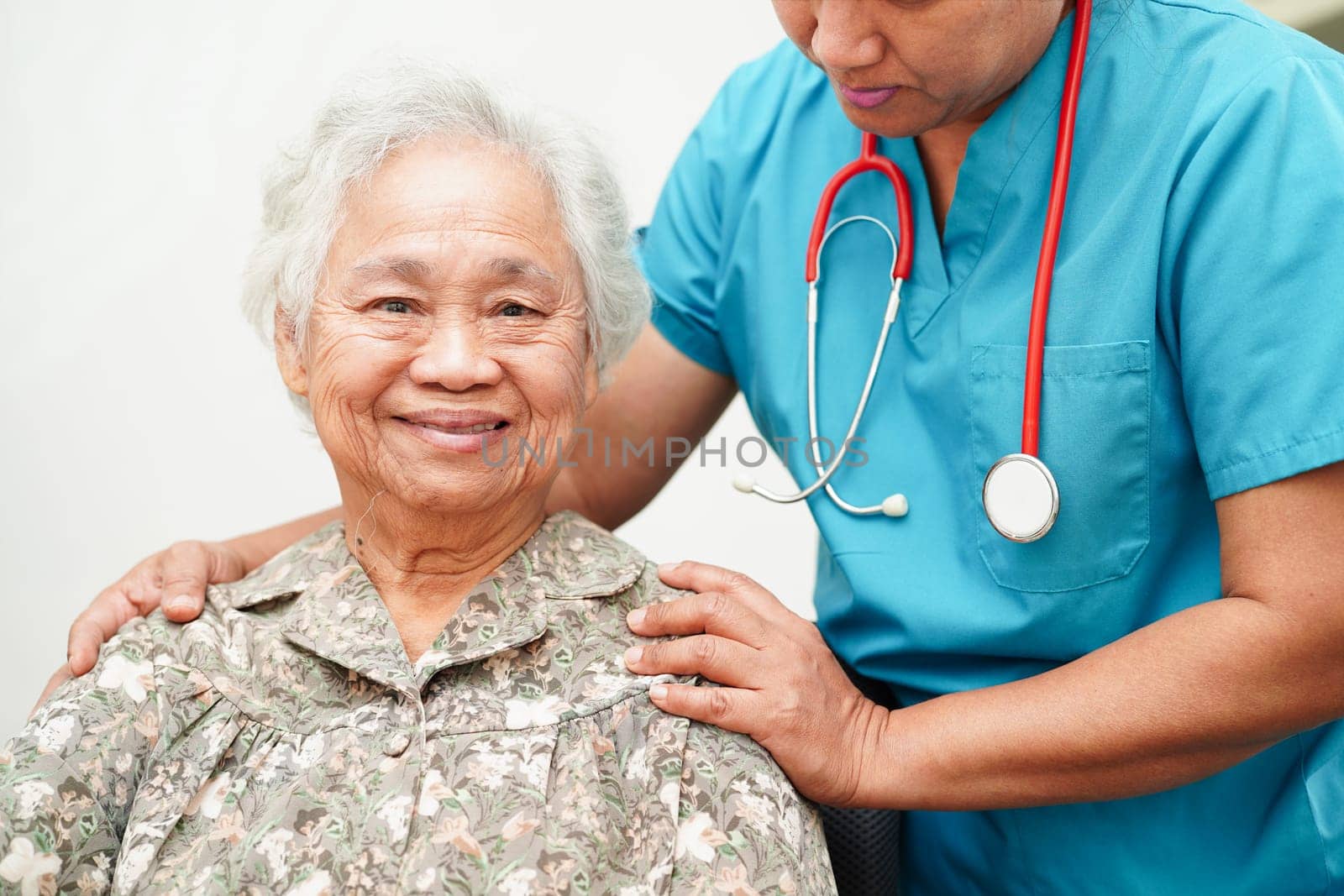 Doctor help Asian elderly woman disability patient sitting on wheelchair in hospital, medical concept.