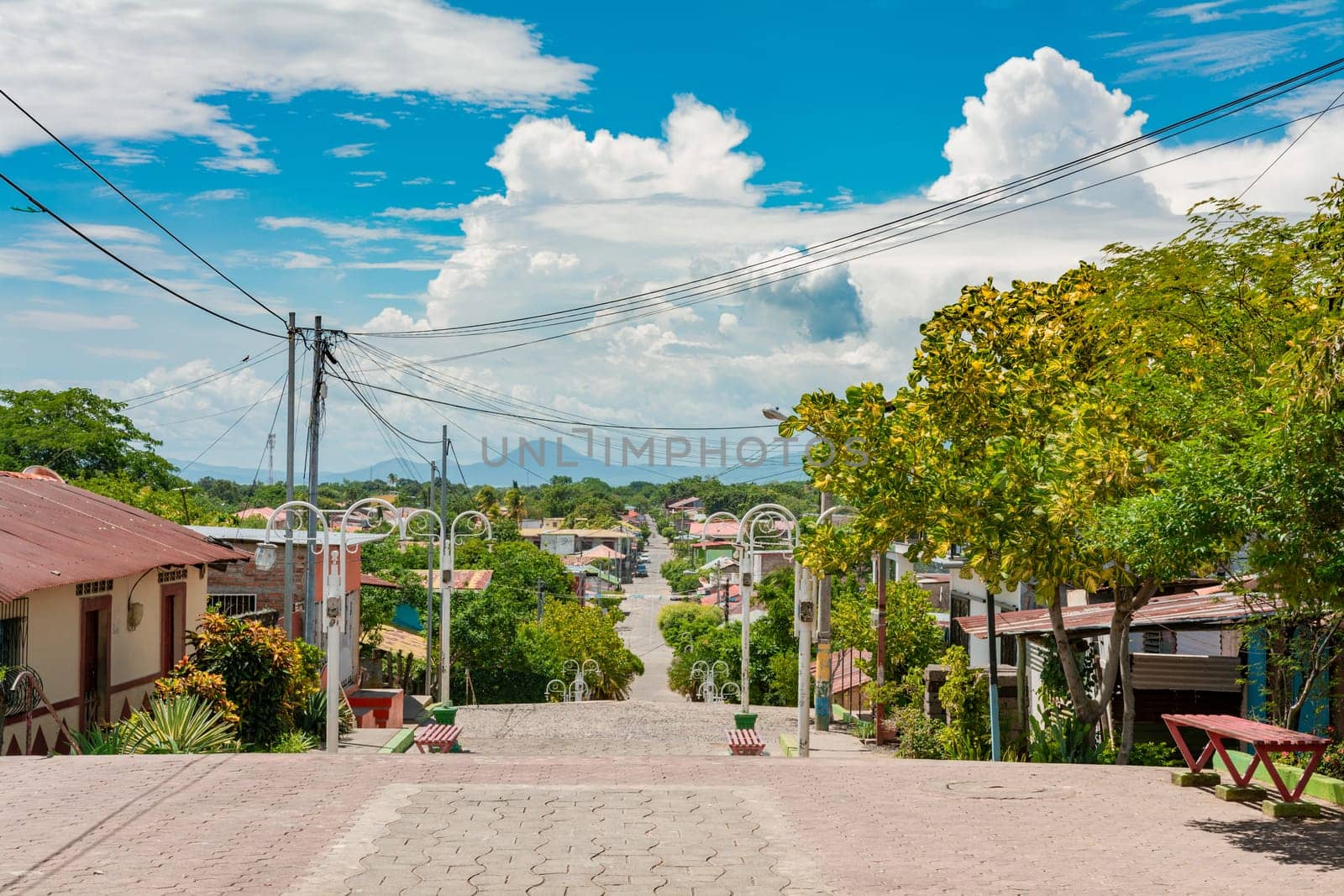 Streets of Nagarote with a view of the momotombo volcano on a suny day. View of the streets of Nagarote with a view of the Momotombo volcano, Nicaragua by isaiphoto