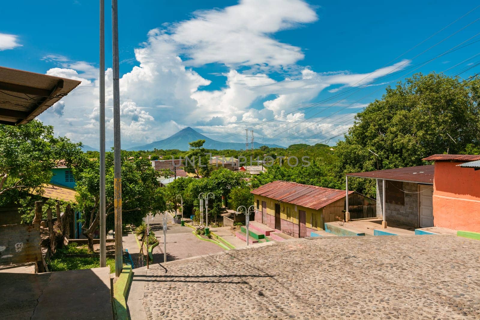 View of the Momotombo volcano, from Nagarote. Streets of Nagarote with a view of the momotombo volcano on a beautiful day by isaiphoto