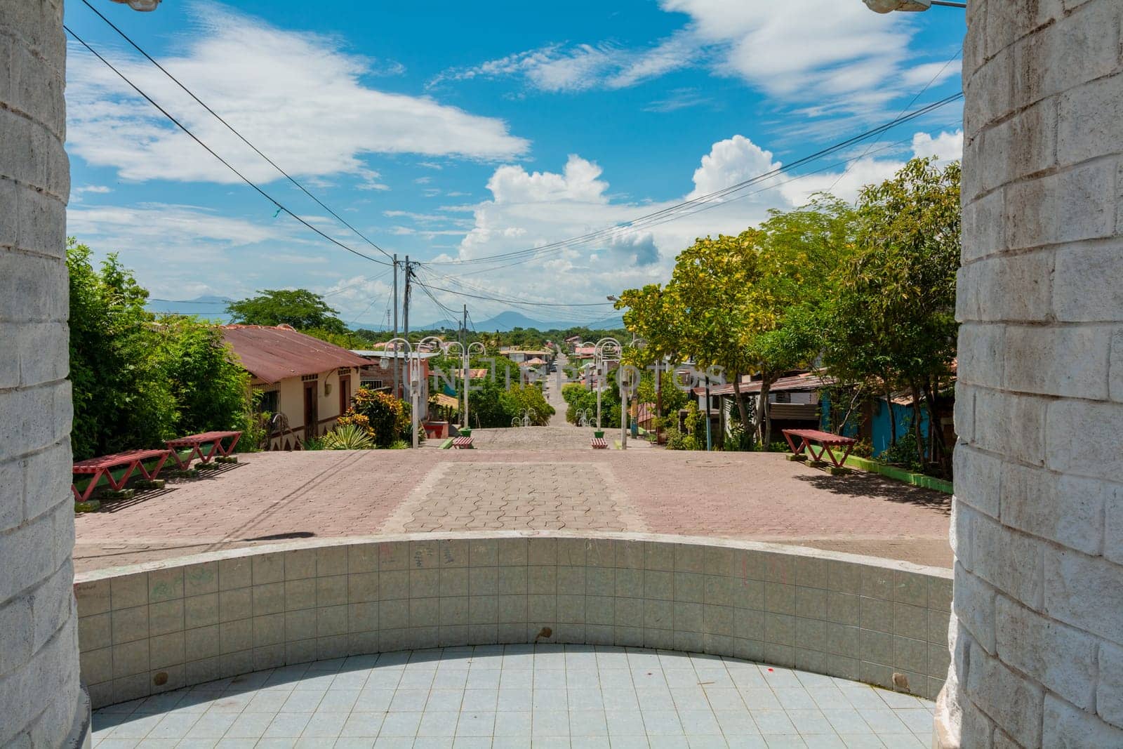 View of the streets of Nagarote with a view of the Momotombo volcano, Nicaragua. Streets of Nagarote with a view of the momotombo volcano on a suny day