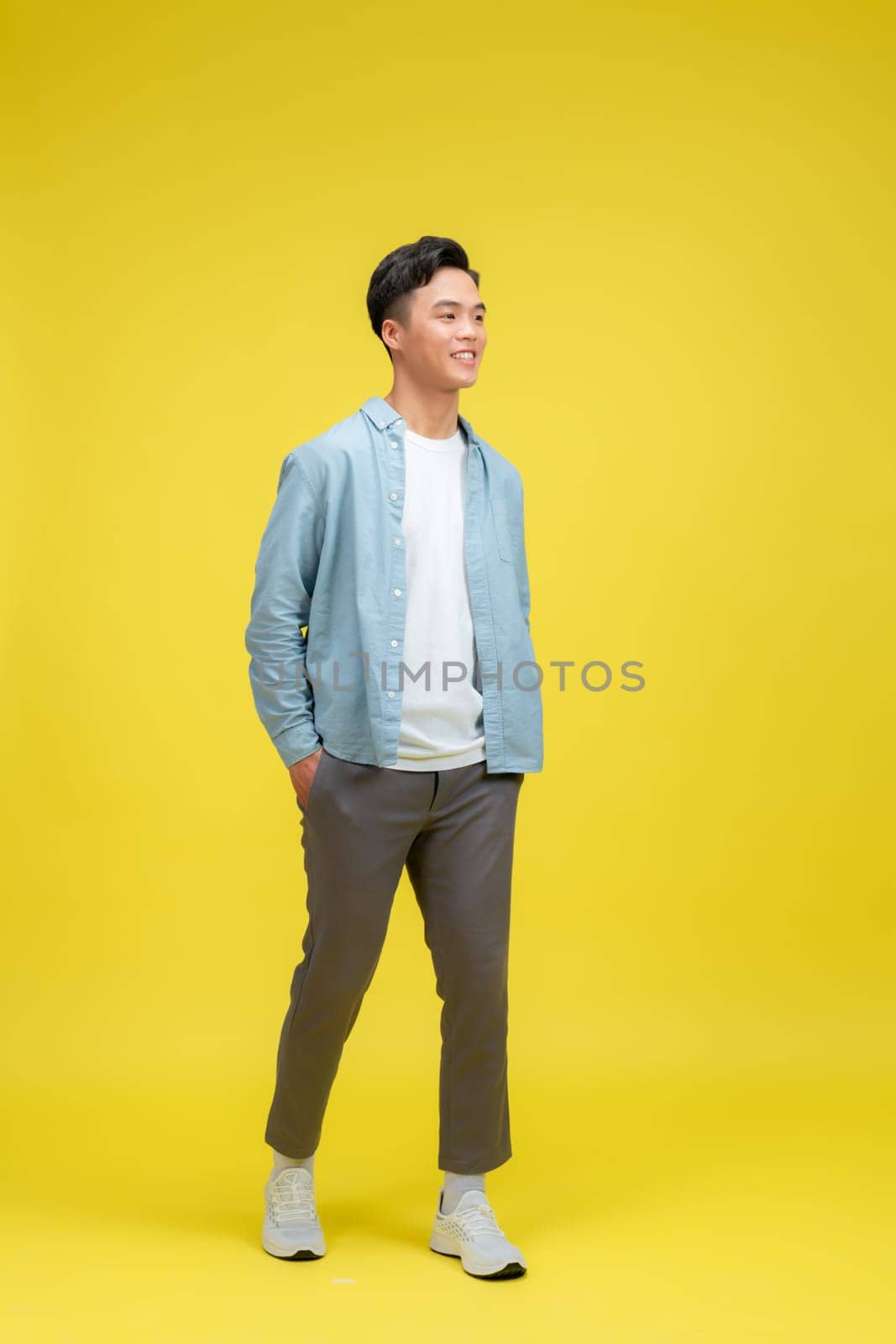 Full length portrait of man standing of front on white background