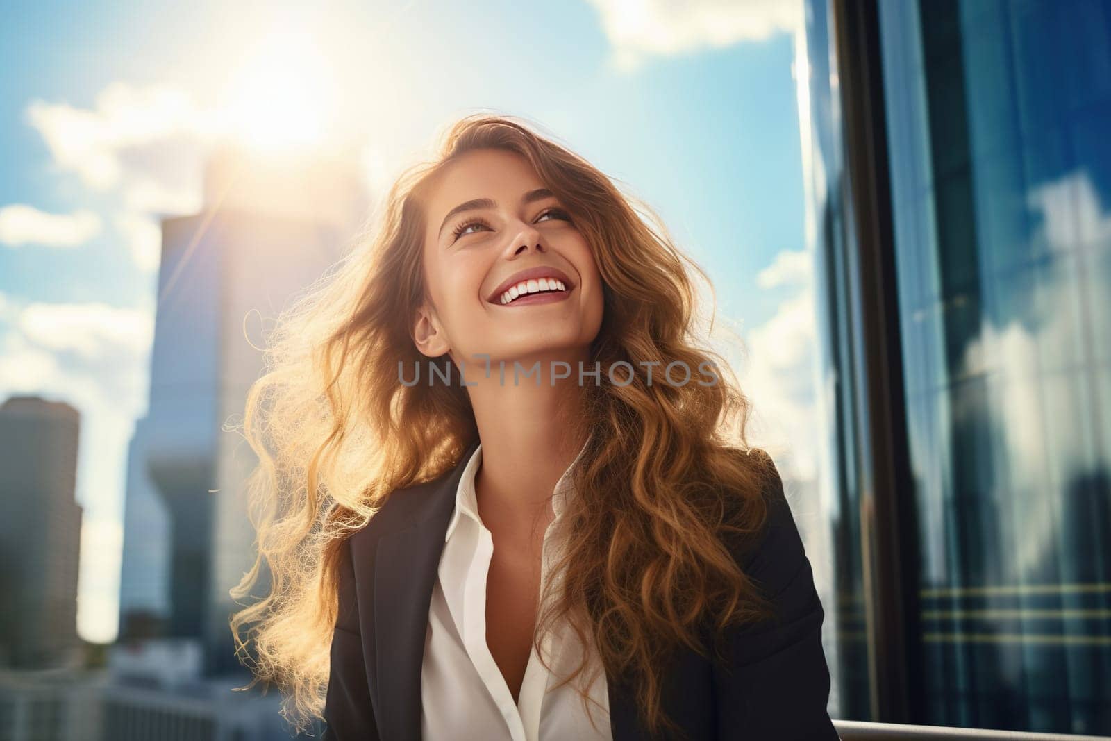 Young woman smiling in the city while looking up the sky