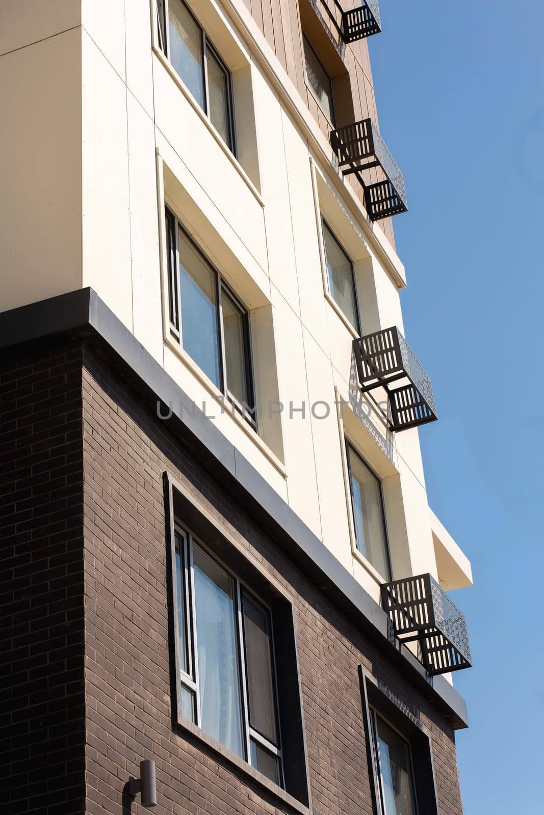 windows of a new multi-storey building against the sky.