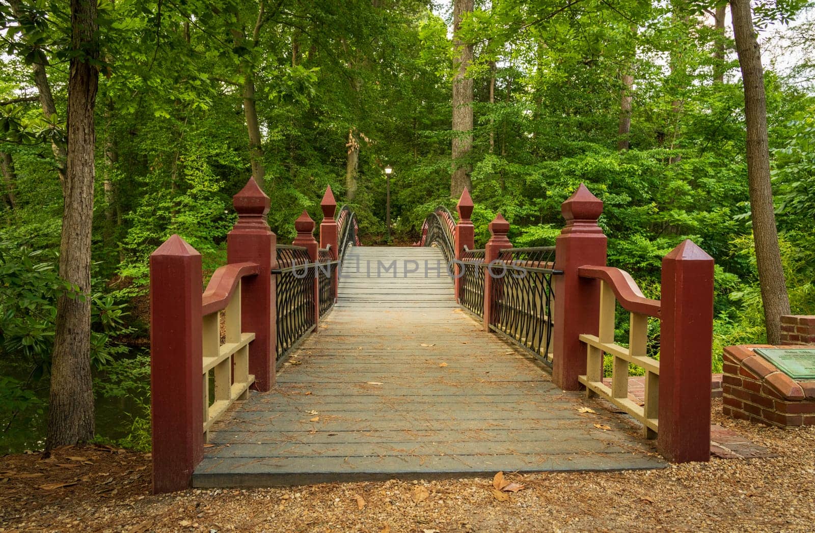 Ornate wooden bridge over Crim Dell on campus of William and Mary college in Williamsburg Virginia