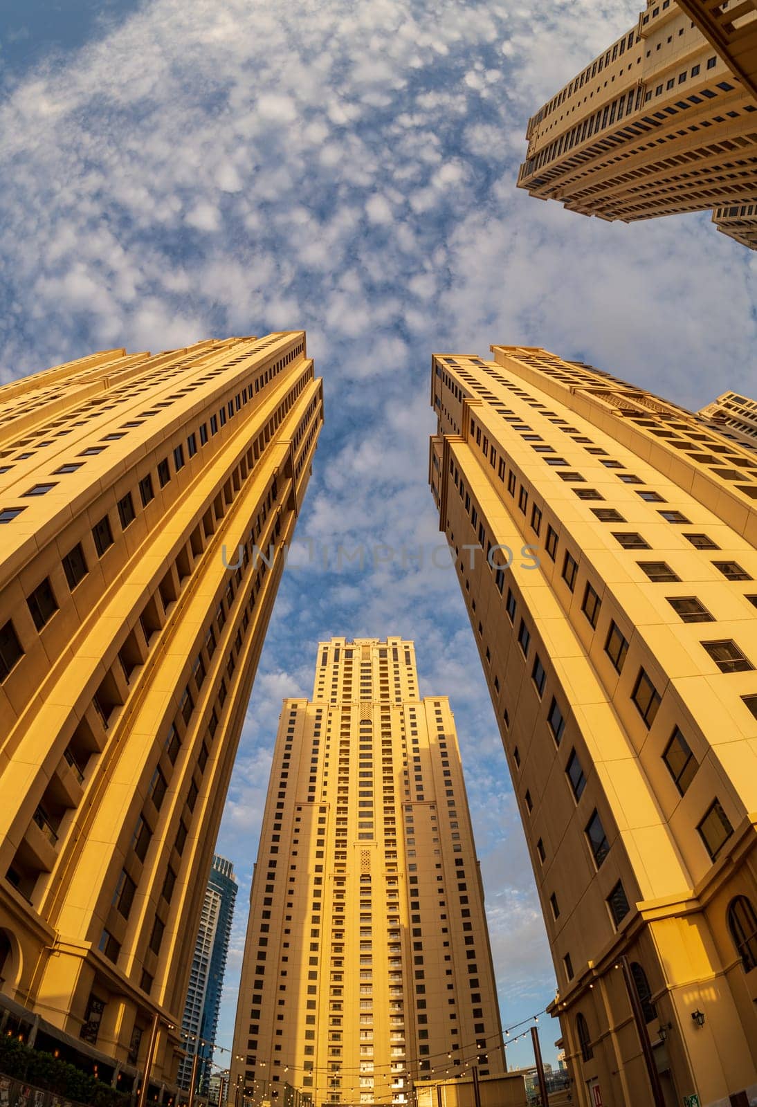 View up to sky with fisheye lens of the hotel towers at JBR Beach in Dubai UAE