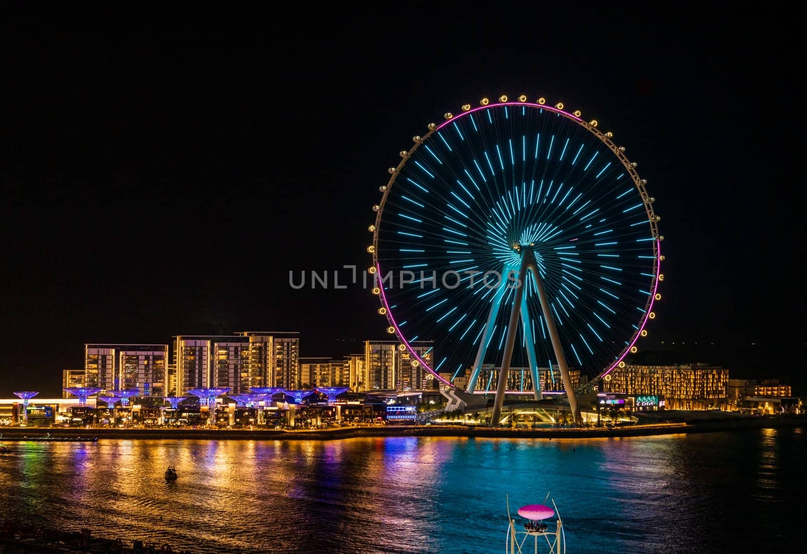 Light show on Ain Dubai observation wheel at sunset by steheap