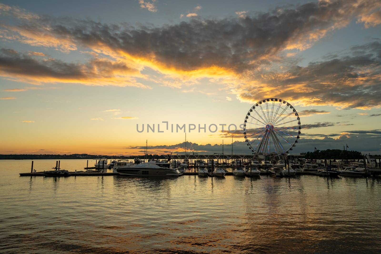 Ferris wheel at National Harbor at sunset by steheap