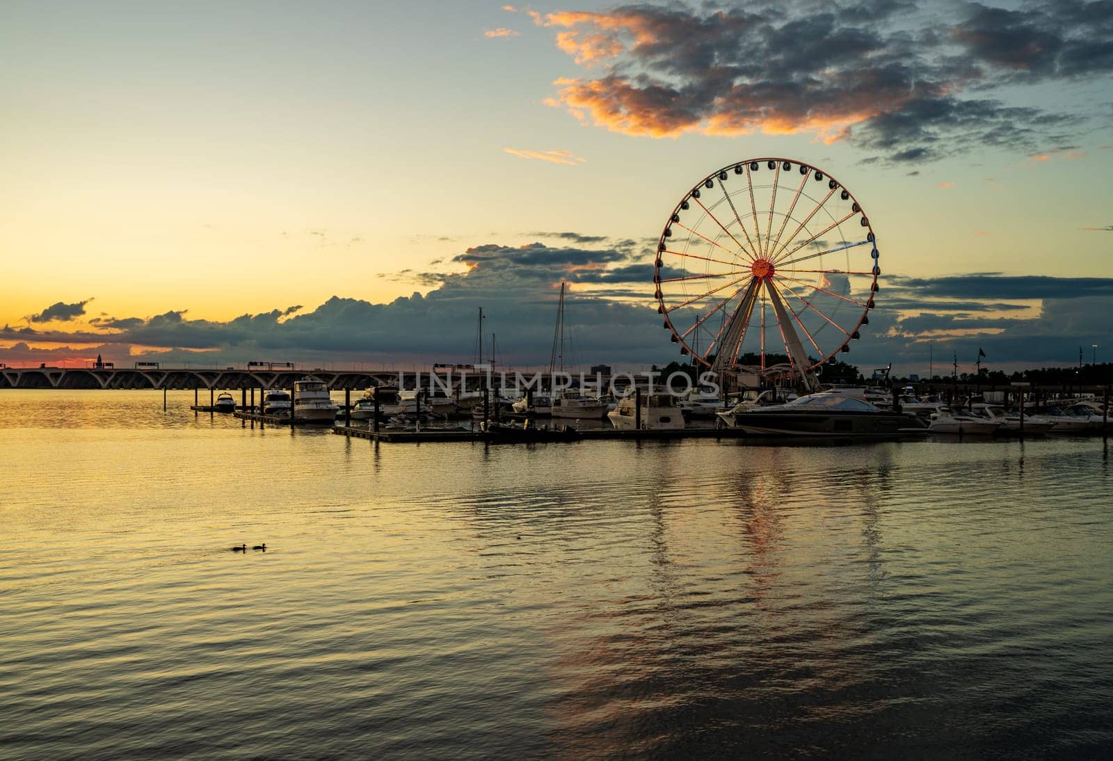 Ferris wheel at National Harbor at sunset by steheap