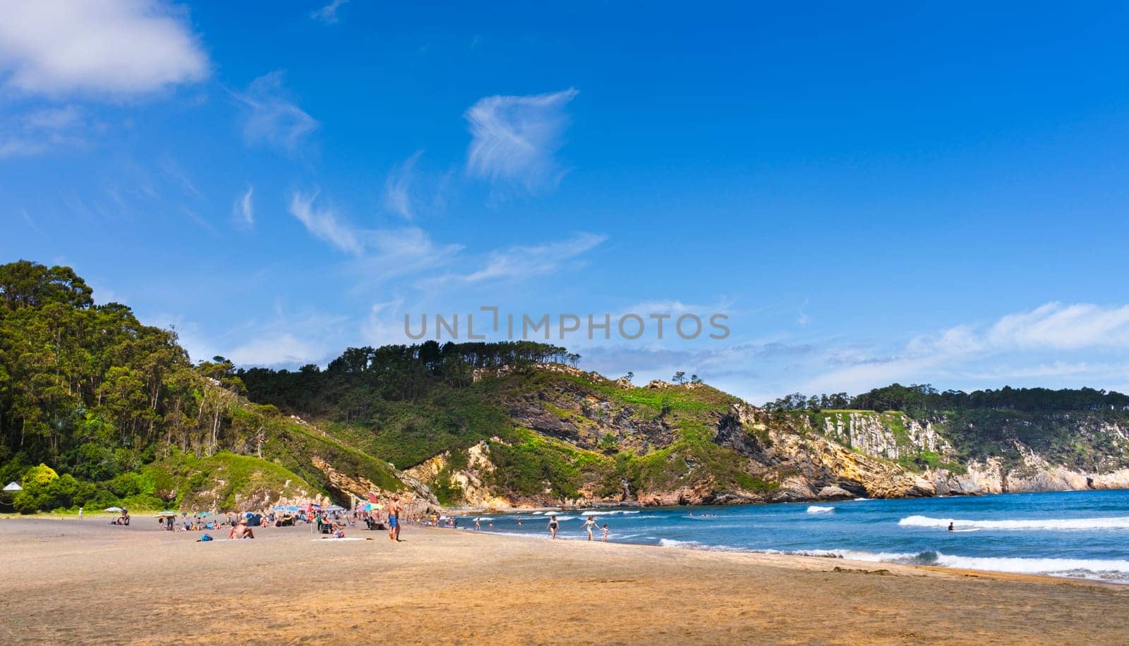 View of Barayo Beach, in the community of Asturias, in summer and with few tourists, with blue sky and light clouds.