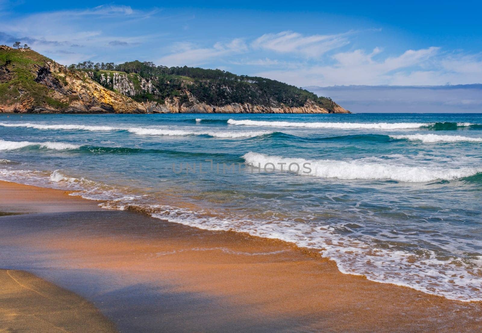 View of Barayo Beach, in the community of Asturias, in summer, with blue sky and light clouds.