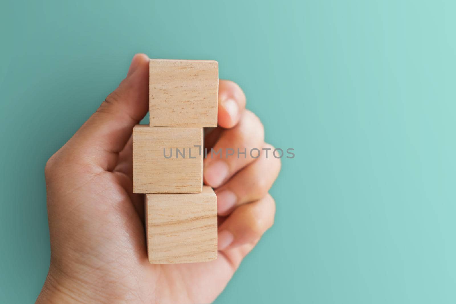 Blank wooden cube that you can put text or icon on in hand hold. by Suwant