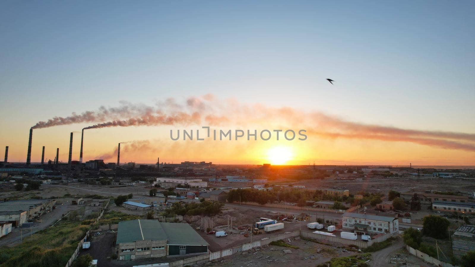 An epic sunset with a view of the smoke of factory by Passcal