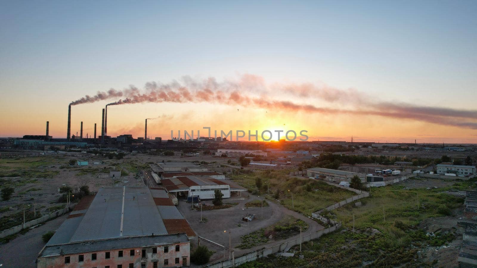 An epic sunset with a view of the smoking factory by Passcal