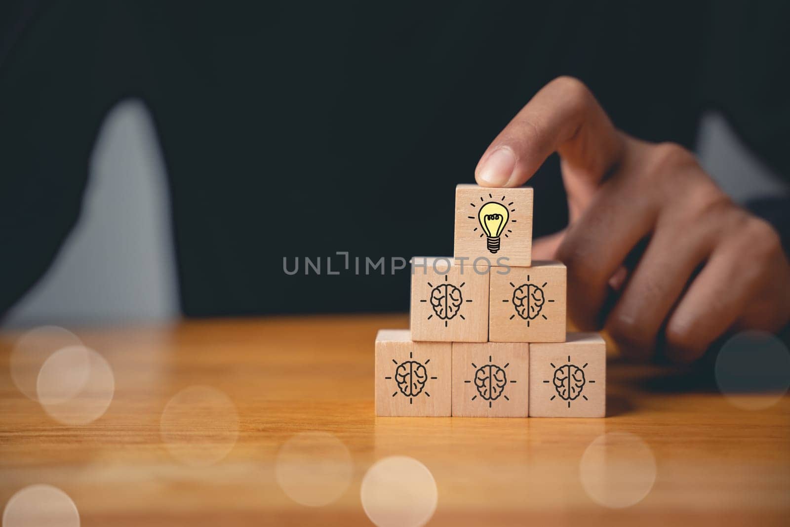 Expertise and support concept. Wooden cubes with light bulb icon on hand icon, suggesting a solution with copy space. Consultation for business development and growth.