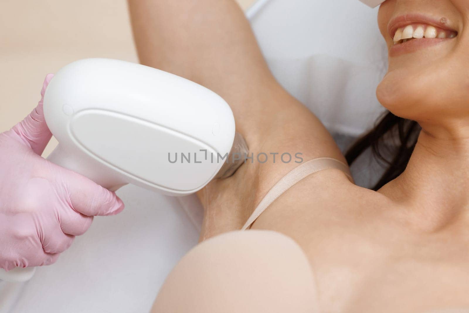 Laser hair removal procedure in the armpit area. Application of sugar paste for the sugaring procedure. Skin care, cosmetic procedures by uflypro