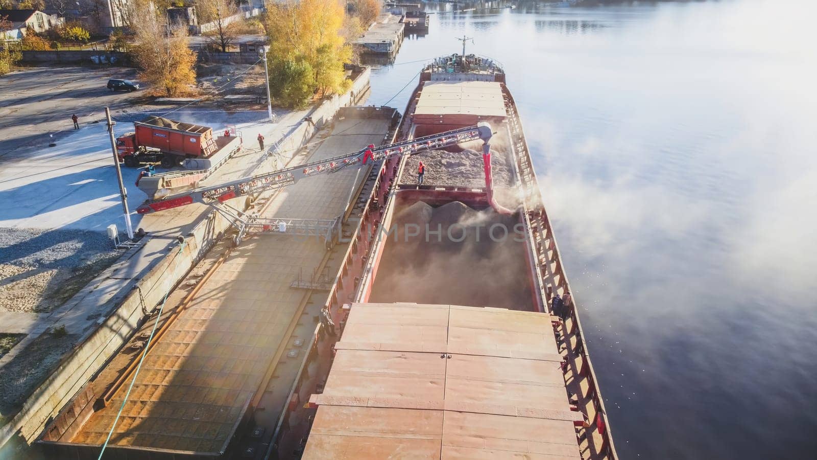 Loading wheat grain into barge, port and food industry grain silos in the port of Ukraine by igor010