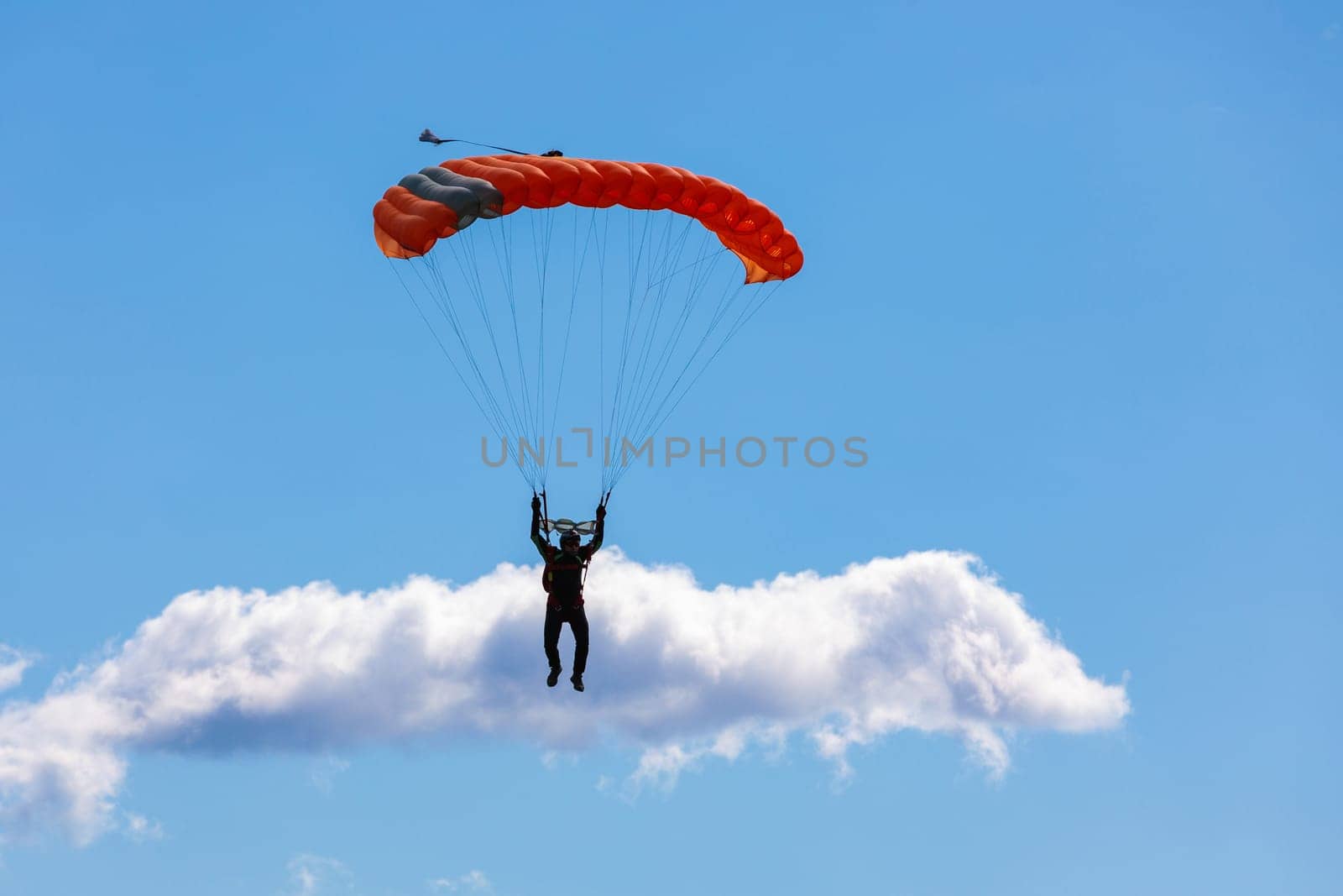 Parachute in the sky. Skydiver is flying a parachute in the blue sky by Yurich32