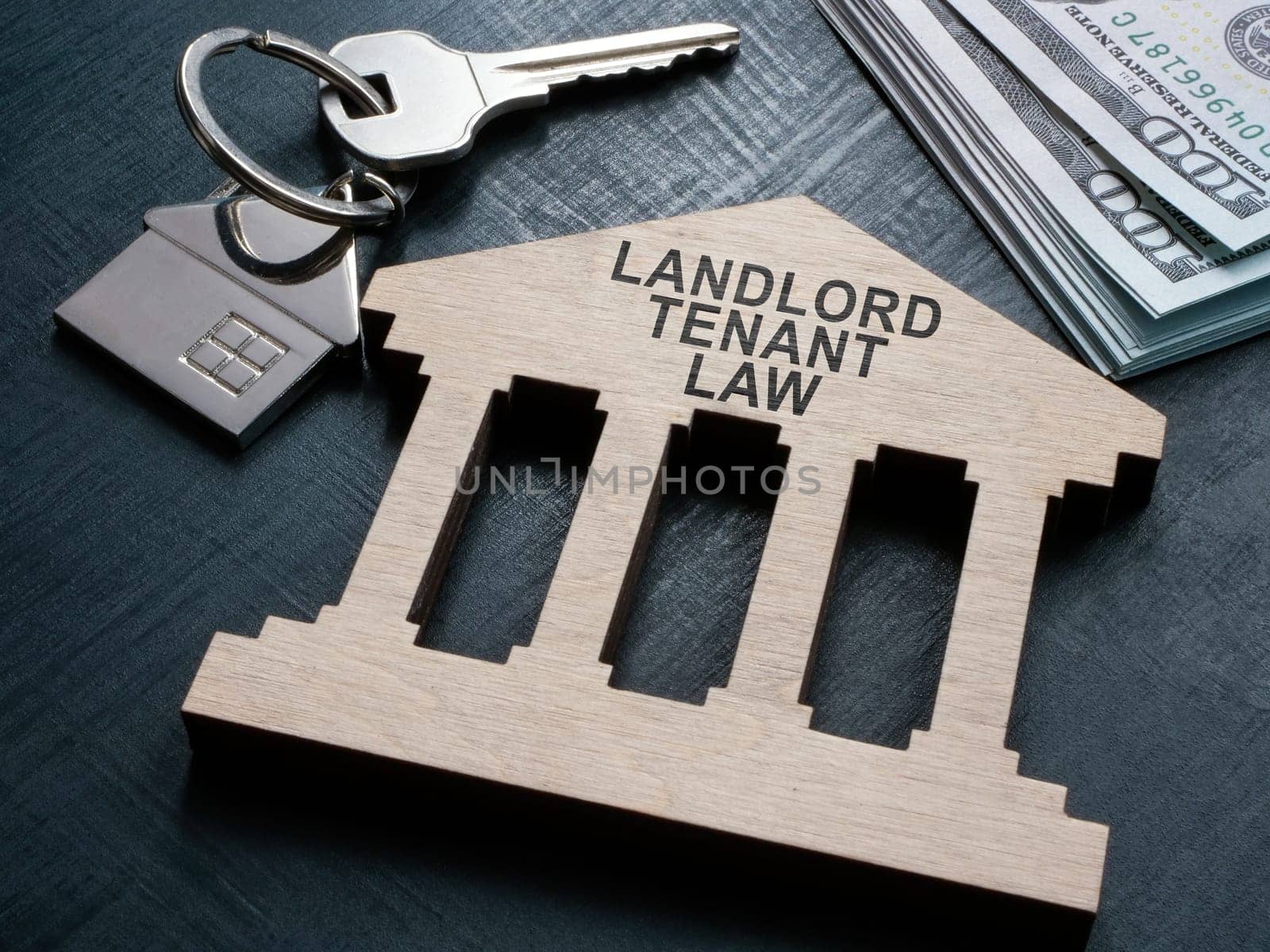 Wooden plate landlord tenant law and key.