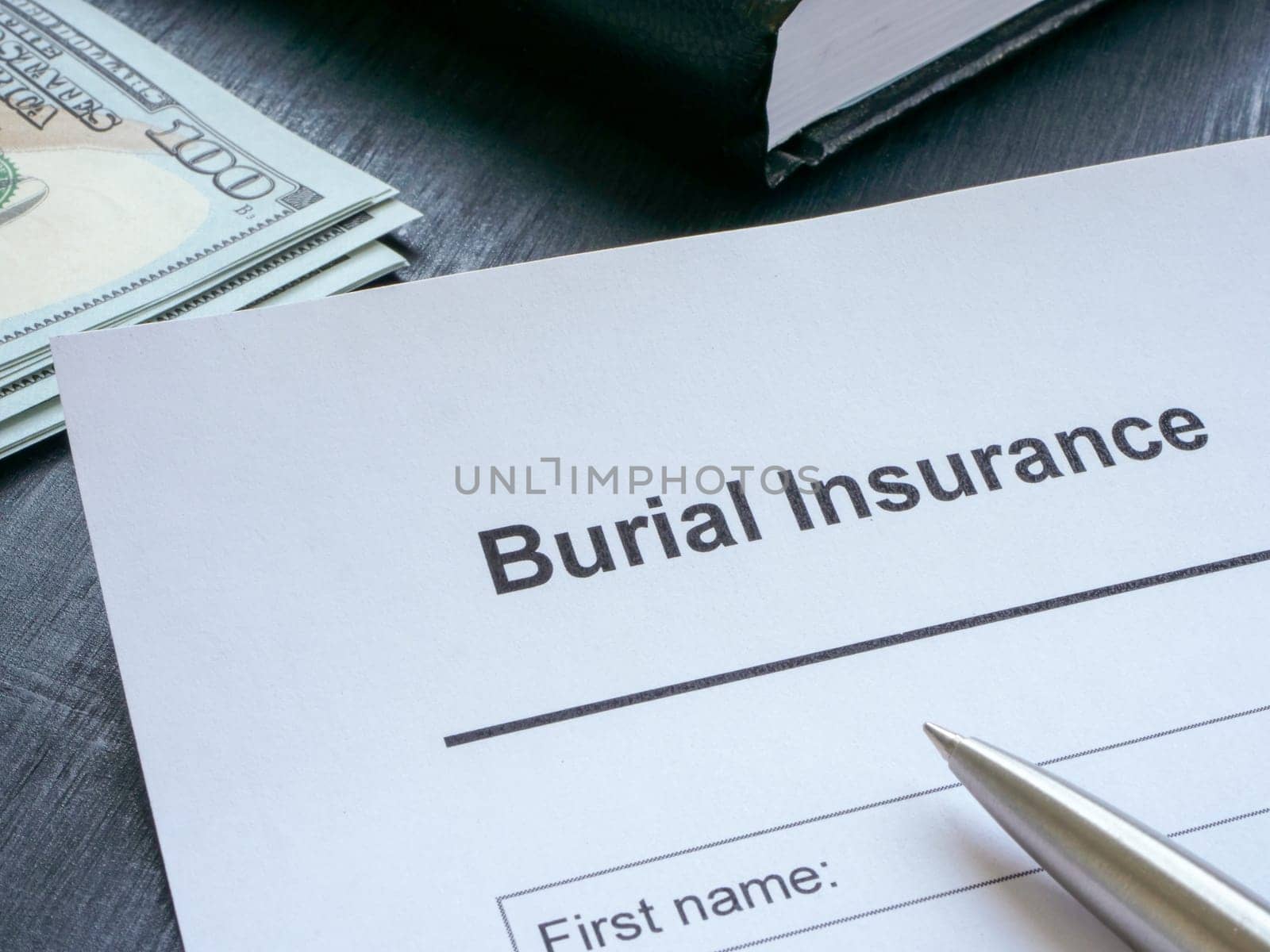 Empty burial insurance application and cash. by designer491