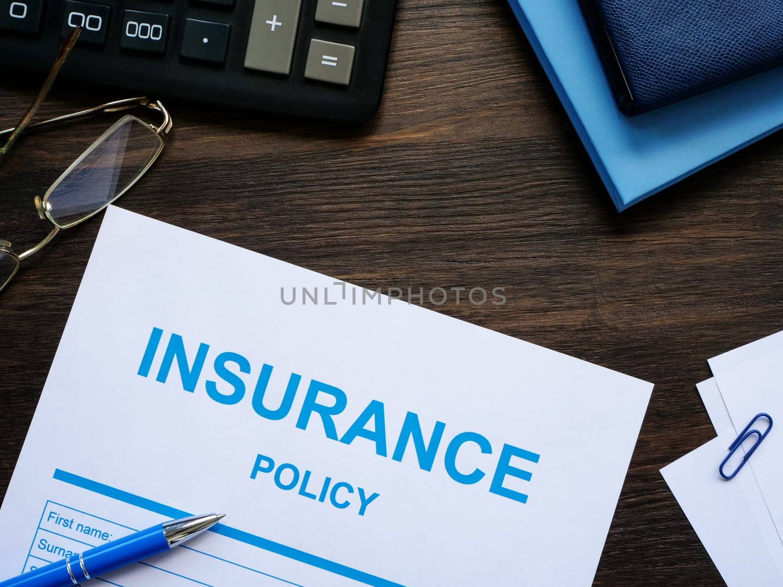 Insurance policy with calculator and notepads.