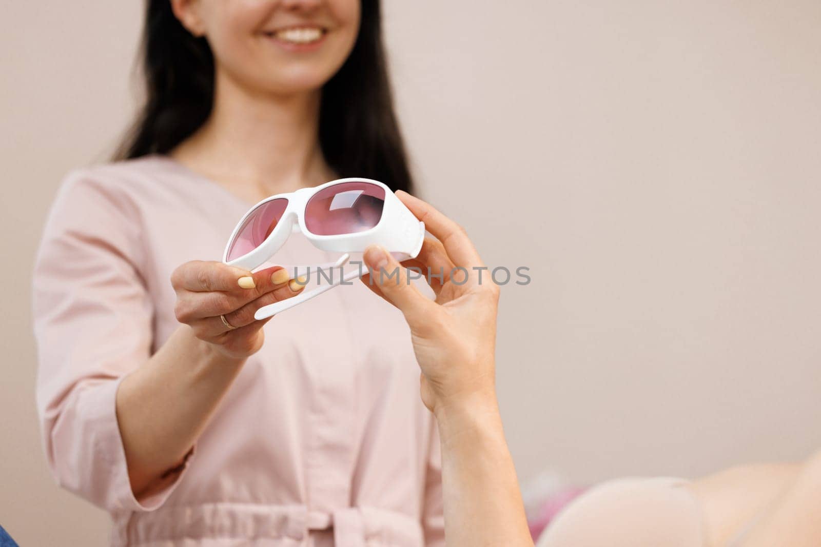 Protective glasses on laser epilation equipment in spa center. Hair removal cosmetology concept.