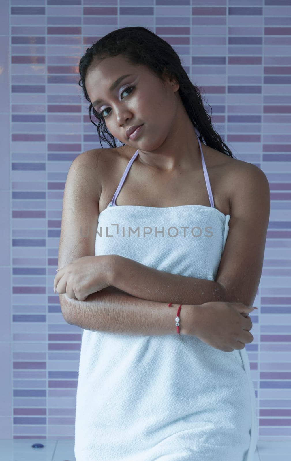 Latina GIRL fresh out of the bathroom relaxing with a white towel and looking at the camera by Raulmartin