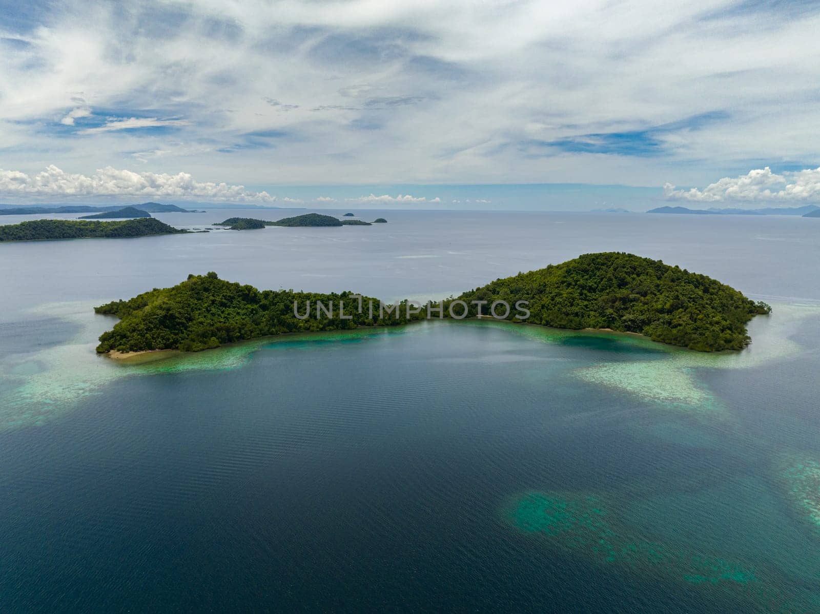 Aerial drone of islands with turquoise water and coral reef. Seascape in the tropics. Borneo, Sabah, Malaysia.