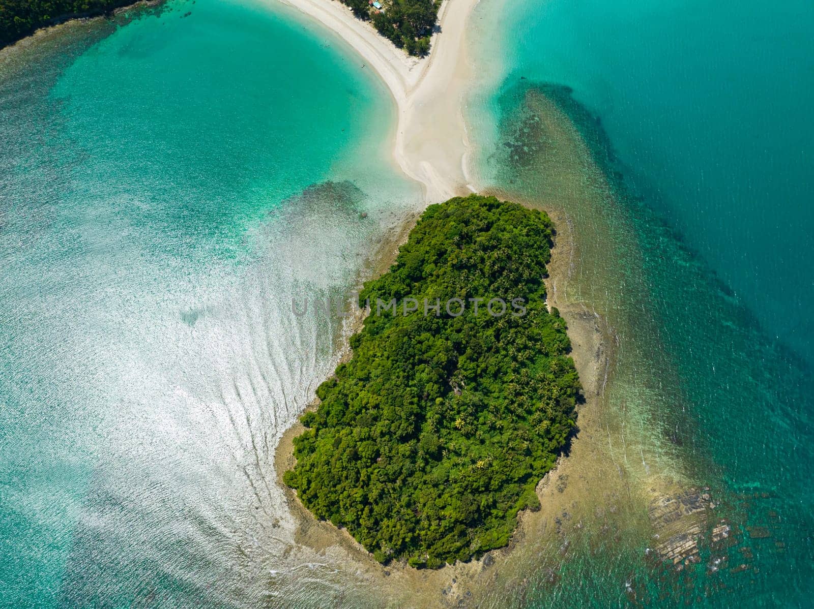 Aerial view of island with sandy beach and turquoise water. Kelambu Beach. Borneo, Malaysia.