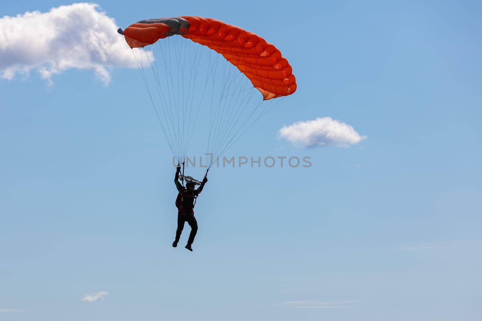 Parachute in the sky. Skydiver is flying a parachute in the blue sky by Yurich32