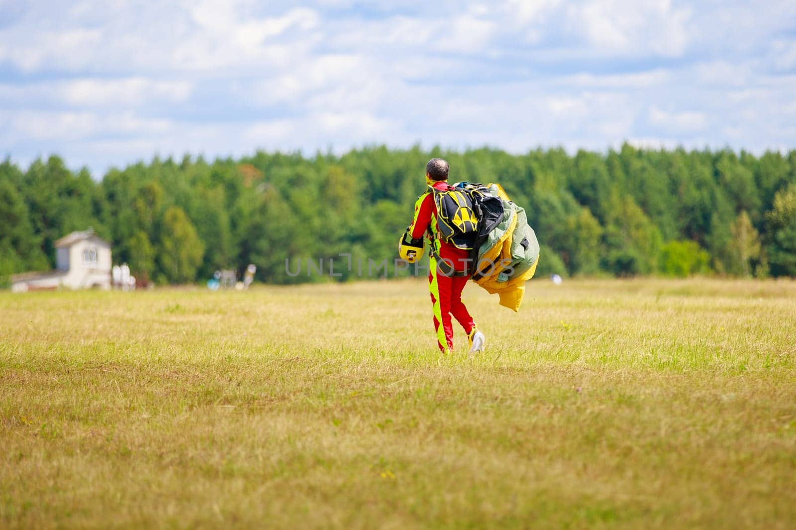 Skydivers-athletes go with a parachute after the jump. High quality photo