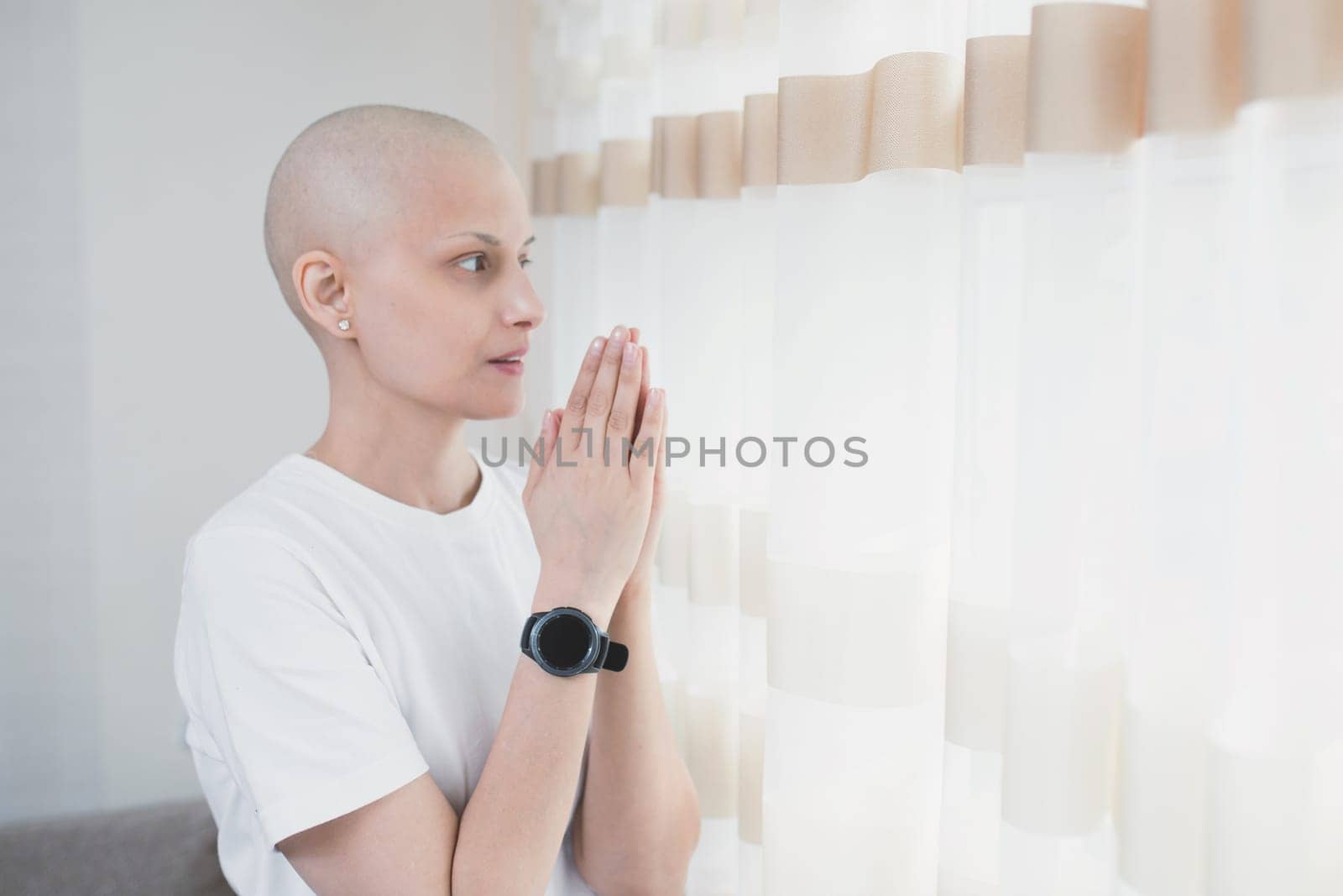 A woman with cancer after chemotherapy thanks the Lord for a successful recovery by Rom4ek
