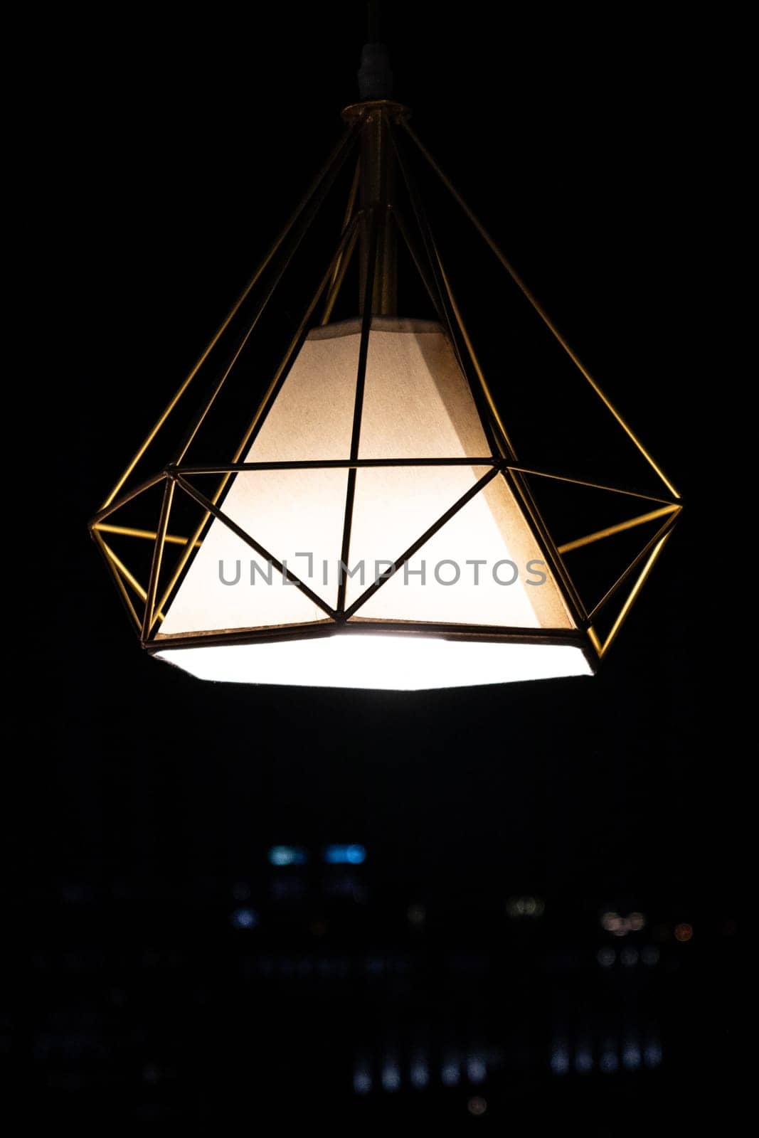Modern garden pendant lamp hanging outdoor terrace during in the dark, copy space, vertical by Rom4ek