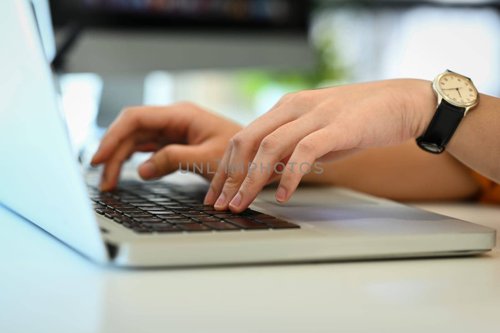 Unrecognizable woman hands typing on laptop keyboard, working in office or browsing information by prathanchorruangsak