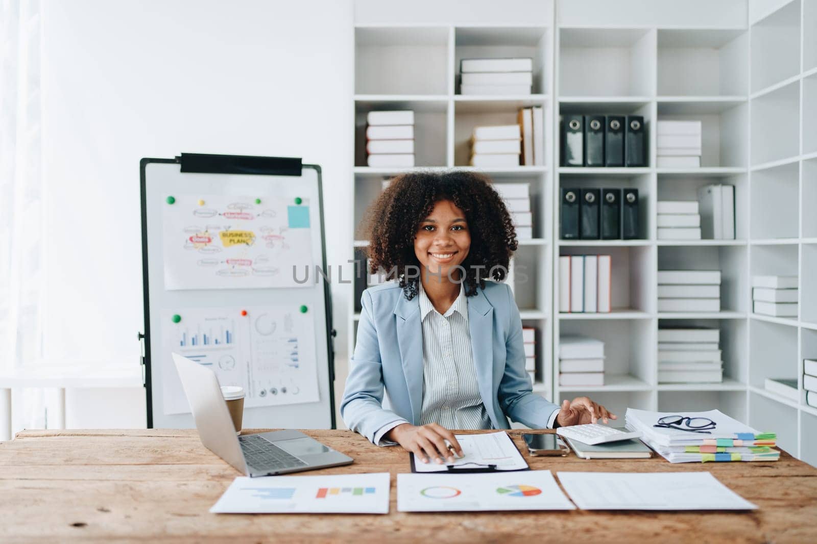 American African business woman using document, computer laptop, calculator, paperwork, documents, in winner and smiling Happy to be successful achievement success. finance and investment concepts.