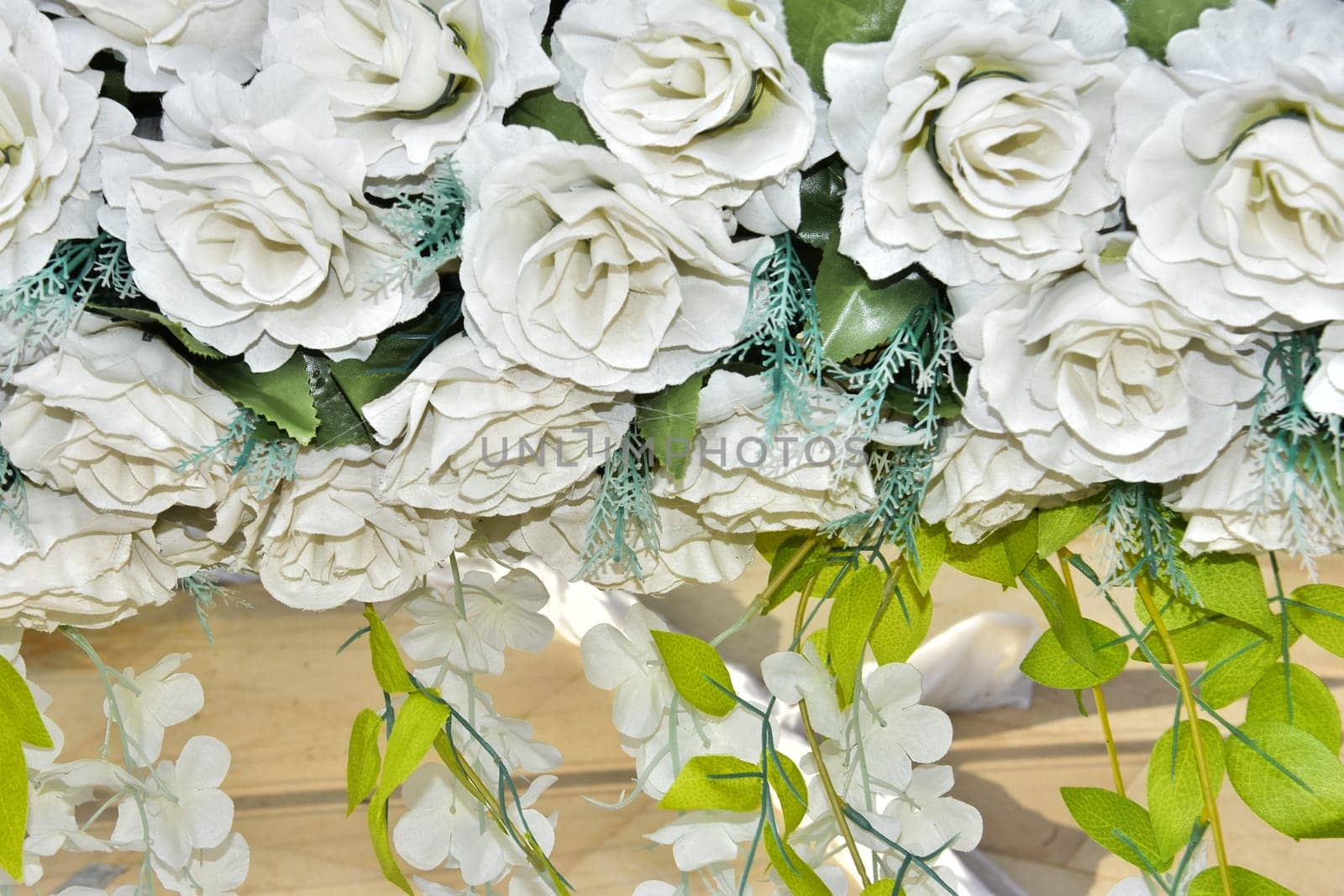 background of large artificial roses for wedding hall decoration. High quality photo