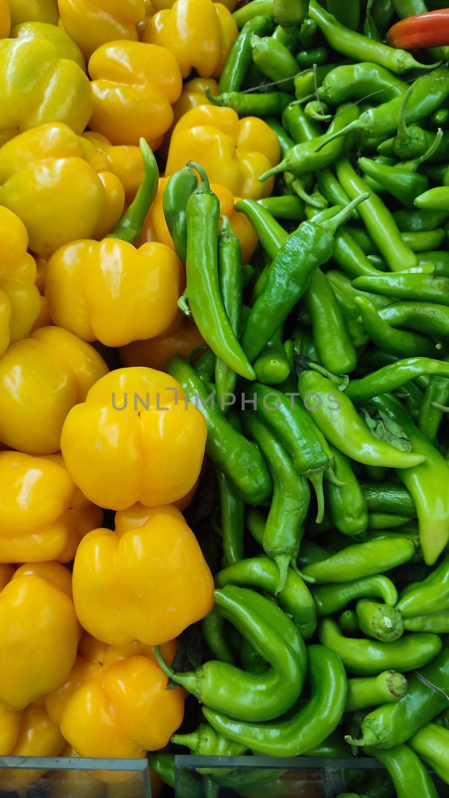 sweet and bitter peppers, and green vegetables summer background, store food. High quality photo