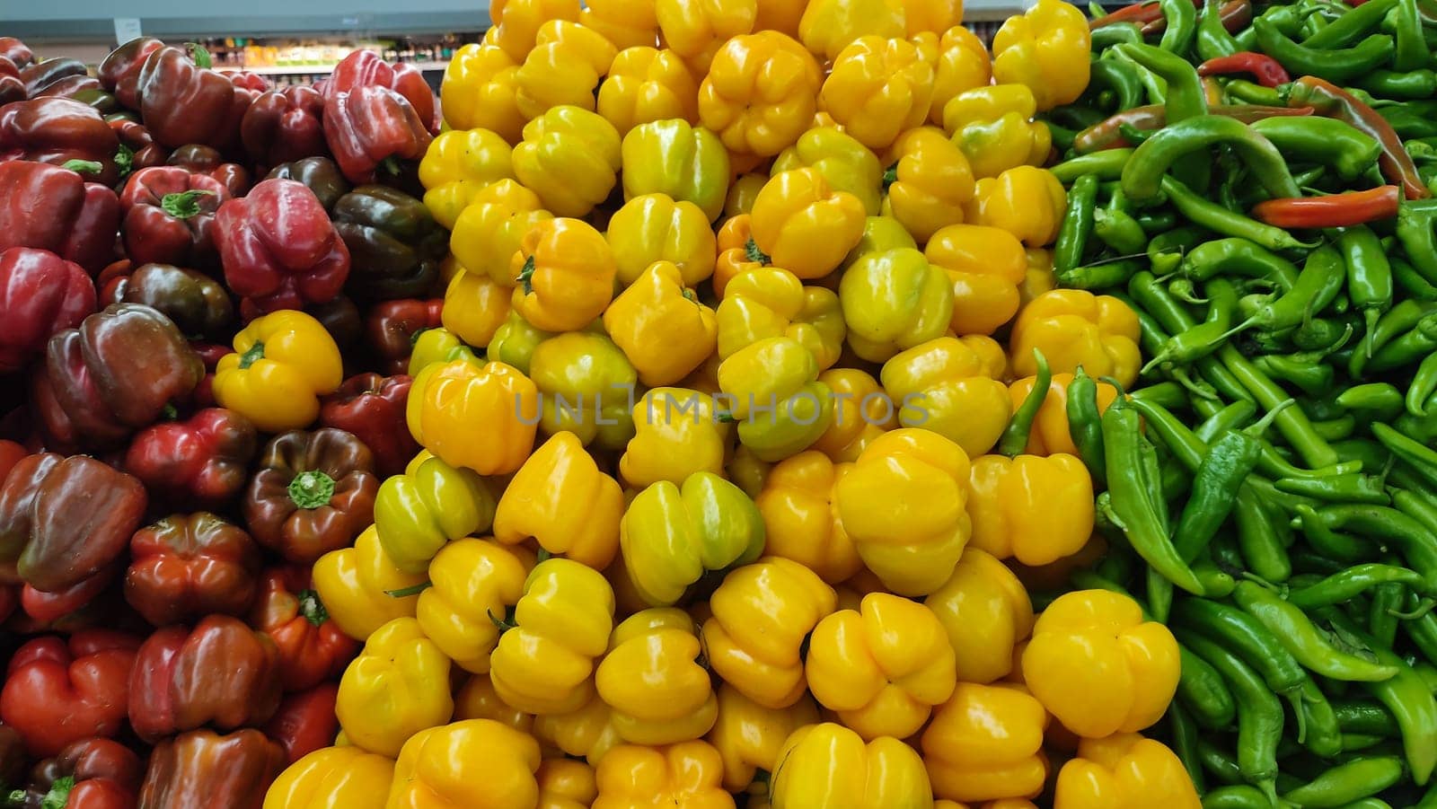 sweet and bitter peppers, red yellow and green vegetables summer background, store food. High quality photo