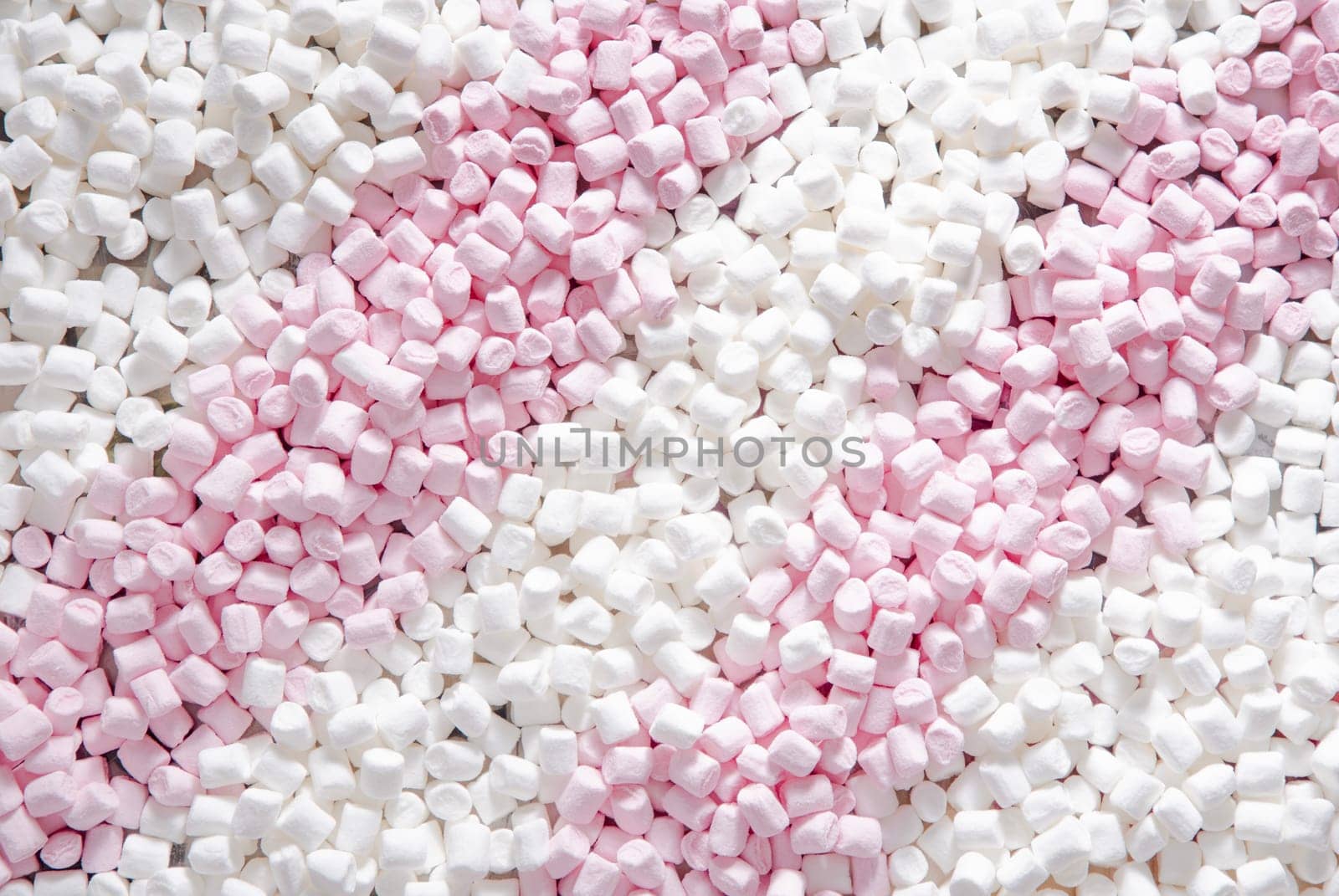 Pink and white mini puffy marshmallows background, closeup texture by KaterinaDalemans