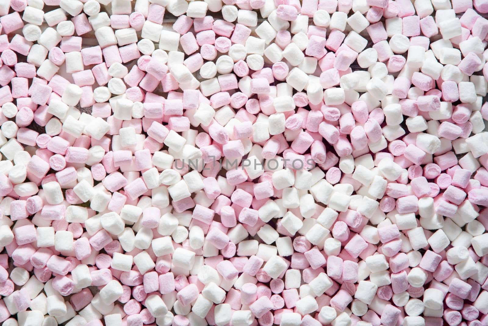 Pink and white mini puffy marshmallows background, closeup texture by KaterinaDalemans