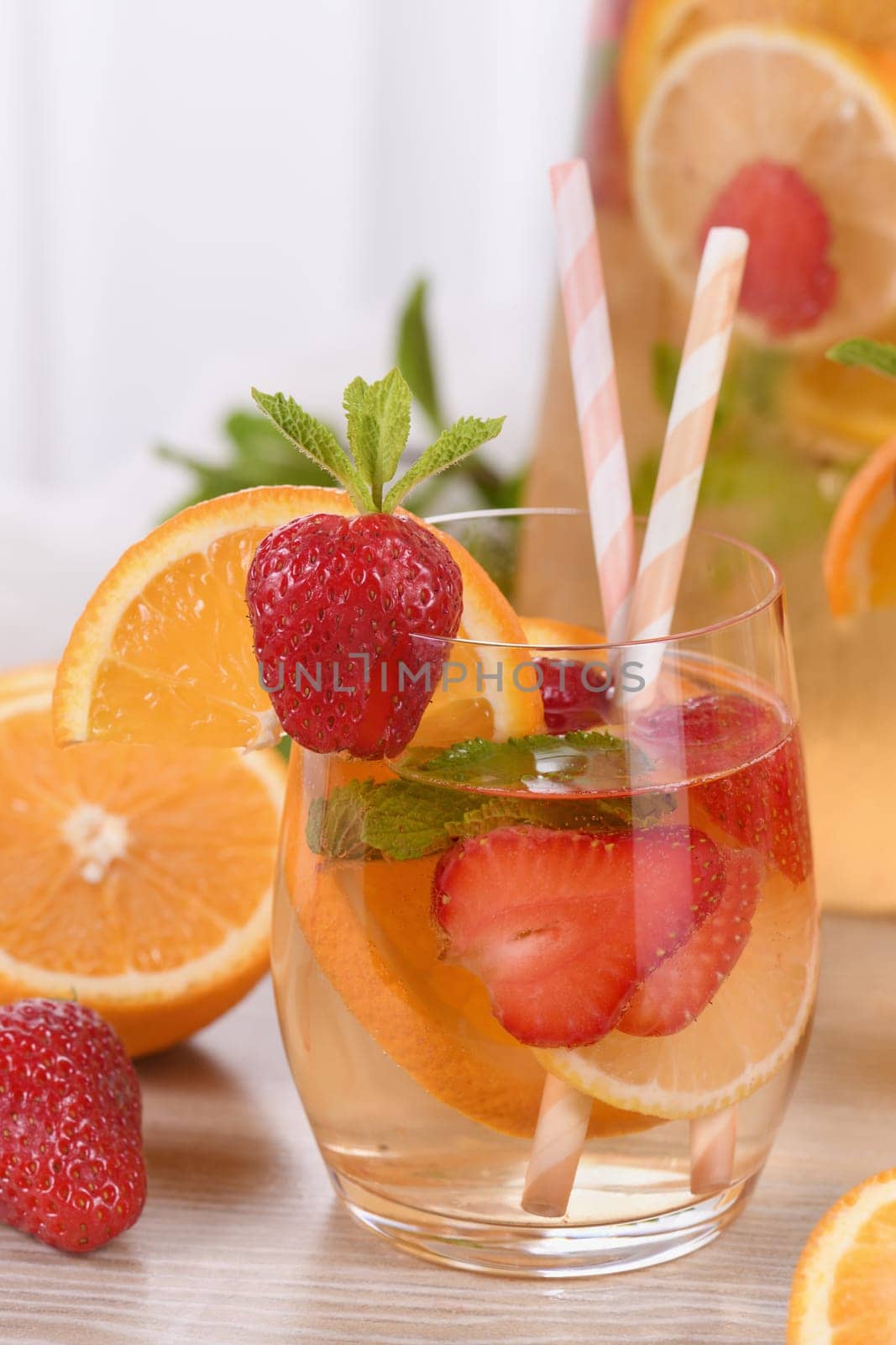 Summer Sangria cocktail or lemonade with strawberry, orange and mint. Refreshing organic non-alcoholic, Detox vitaminized healthy drink, fruit in a glass