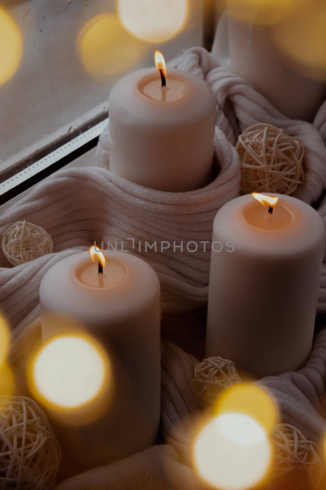 Bokeh light Home fragnance concept autumn holidays at cozy home on the windowsill Hygge aesthetic atmosphere on knitted white sweater. Still life of micro moment candid slow living. Mental health wellbeing exercises Raining Outside