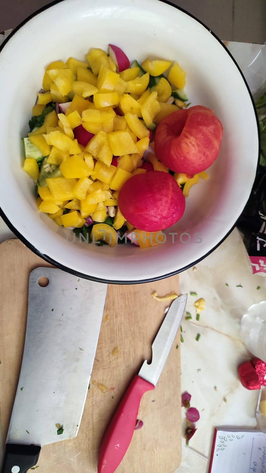 fresh salad of yellow sweet peppers and tomato, vegetables food in a white bowl products, red-yellow background. High quality photo