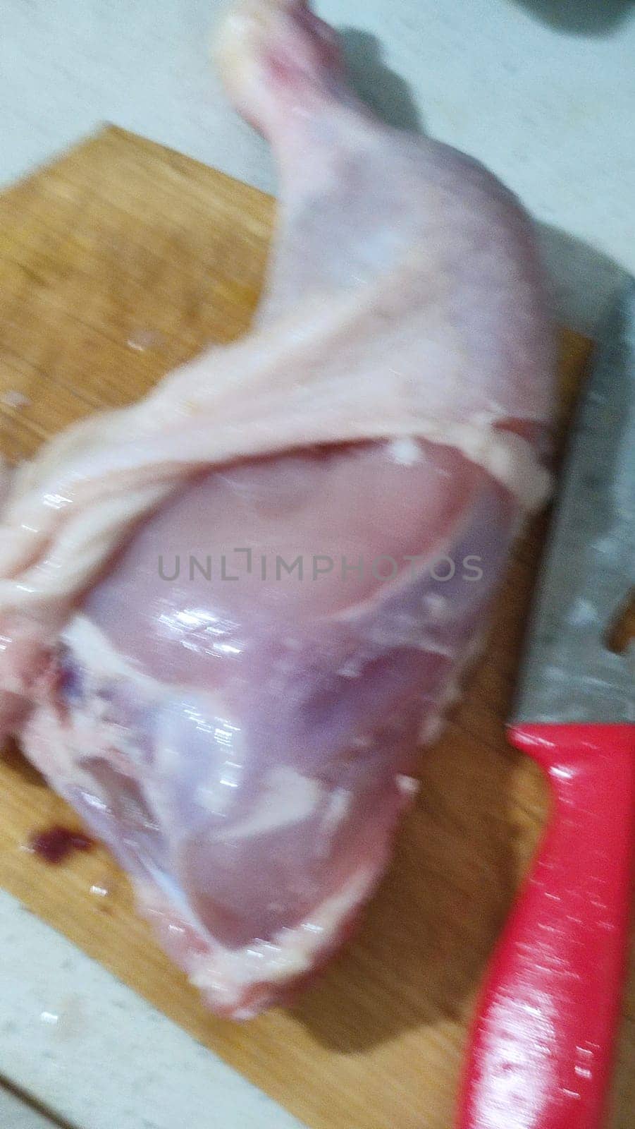 fresh food, chicken leg on kitchen board, cooking knife. High quality photo