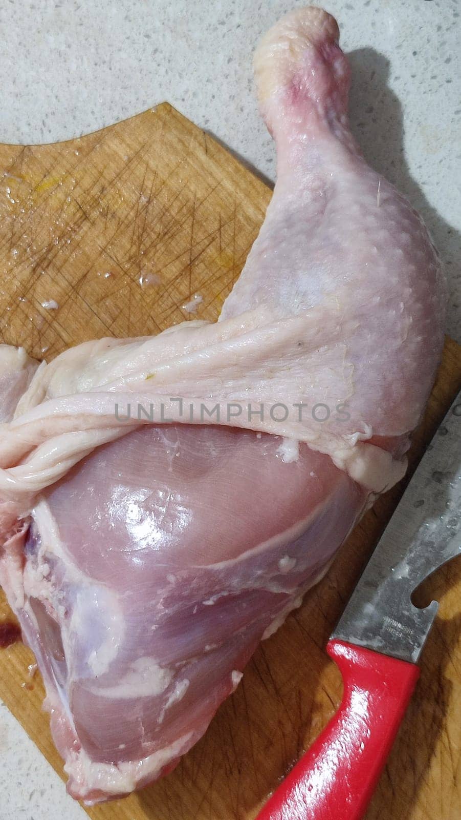 fresh food, chicken leg on kitchen board, cooking knife. High quality photo