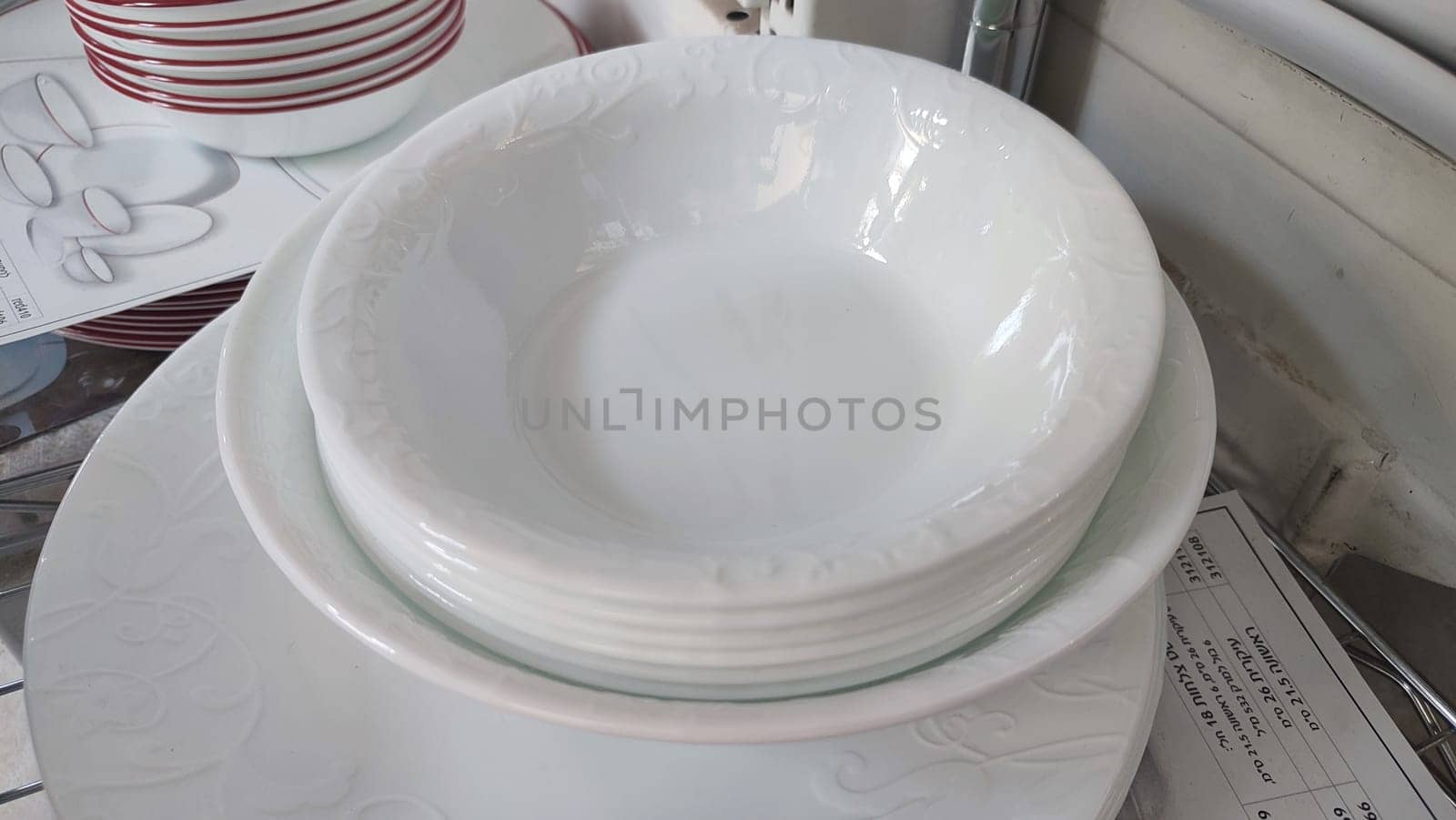 white deep clean plates stacked in a slide,. High quality photo