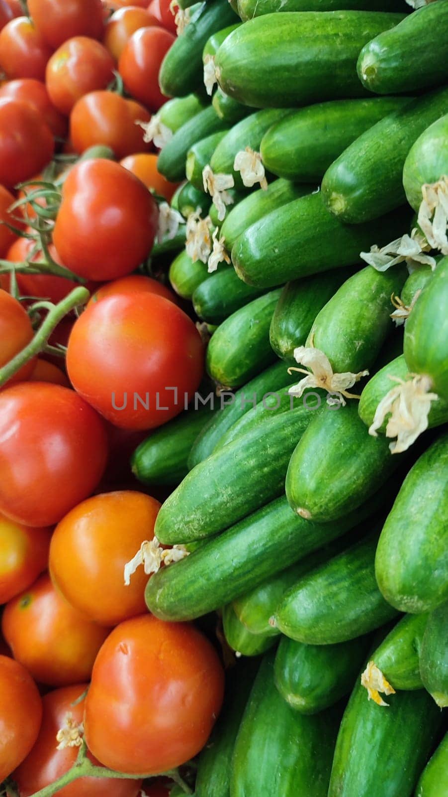 tomatoes and green cucumbers fresh vegetables lie in the grocery store, fresh food, vegetarianism. High quality photo
