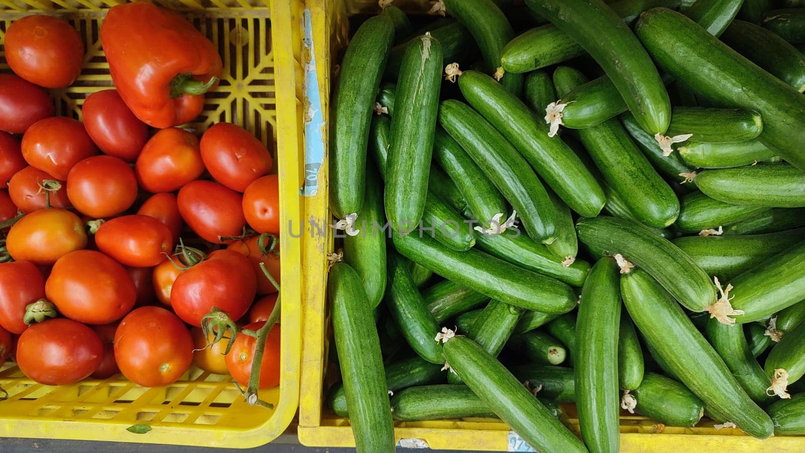 tomatoes and green cucumbers fresh vegetables lie in the grocery store, fresh food, vegetarianism. High quality photo