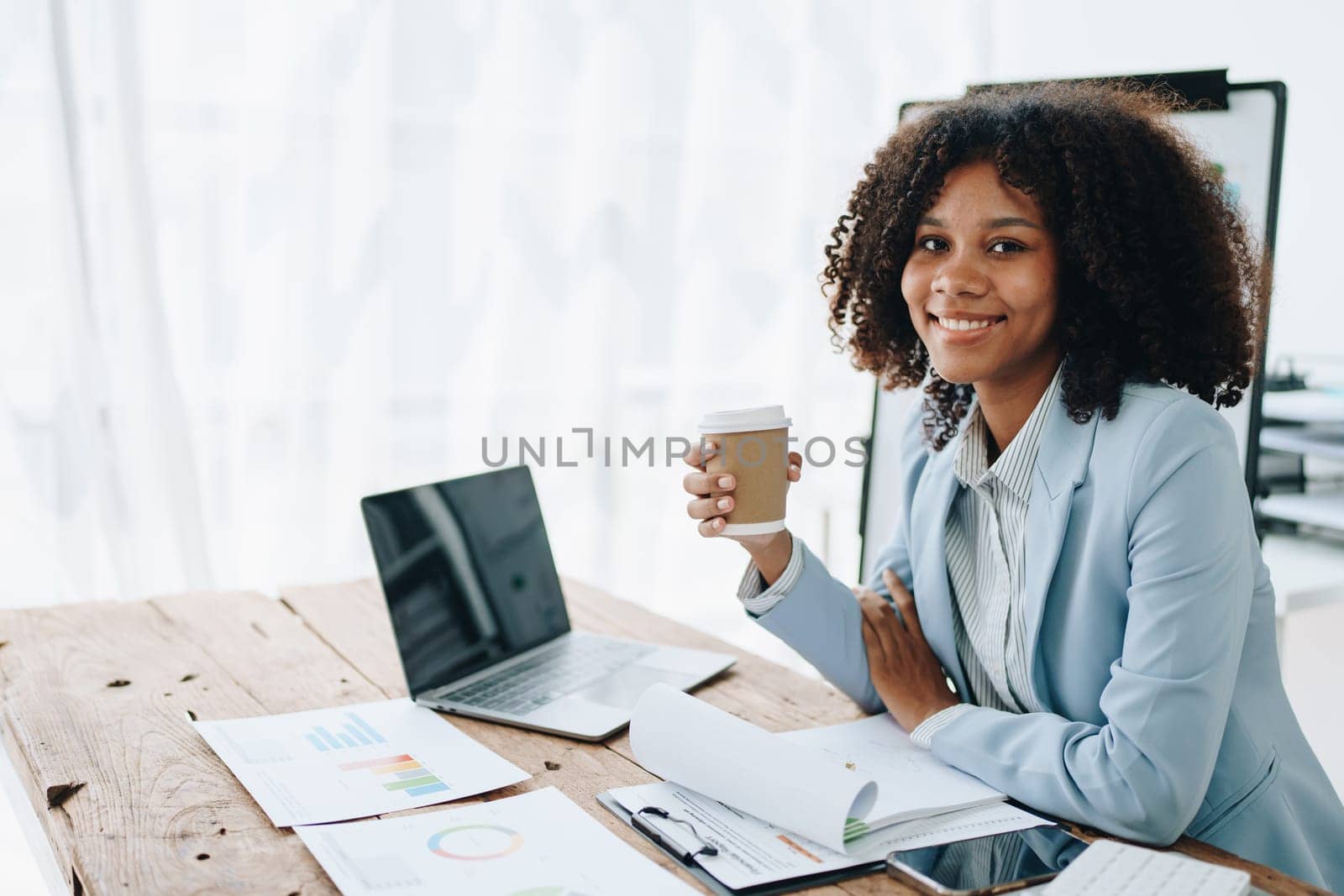 American African business woman using document, computer laptop, calculator, paperwork, documents, in winner and smiling Happy to be successful achievement success. finance and investment concepts by Manastrong